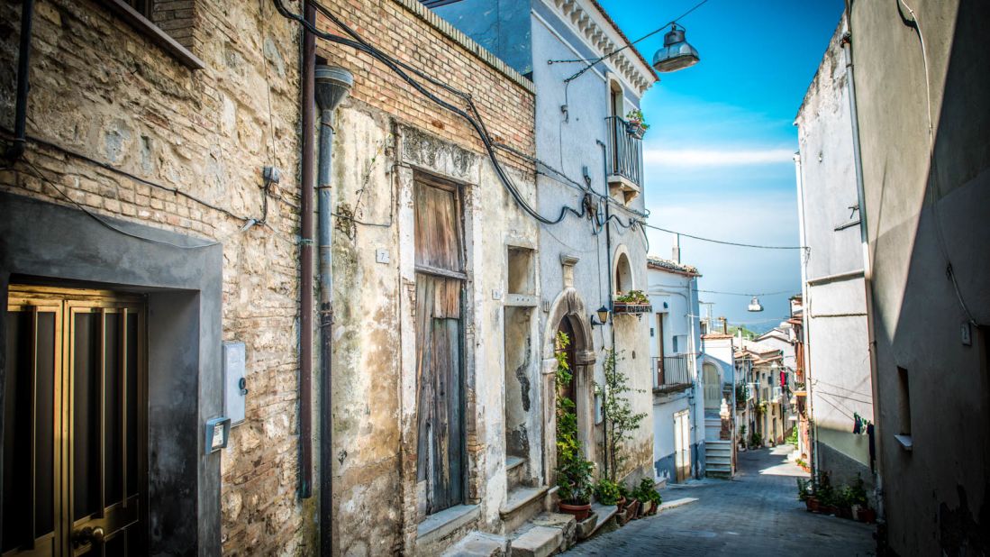 <strong>Old and new: </strong>Biccari's cobblestone alleys are lined with old and brightly colored newer houses. Crumbling stone dwellings with cracked wooden doors, broken window panes and peeling wall paint are juxtaposed with picture-perfect homes.