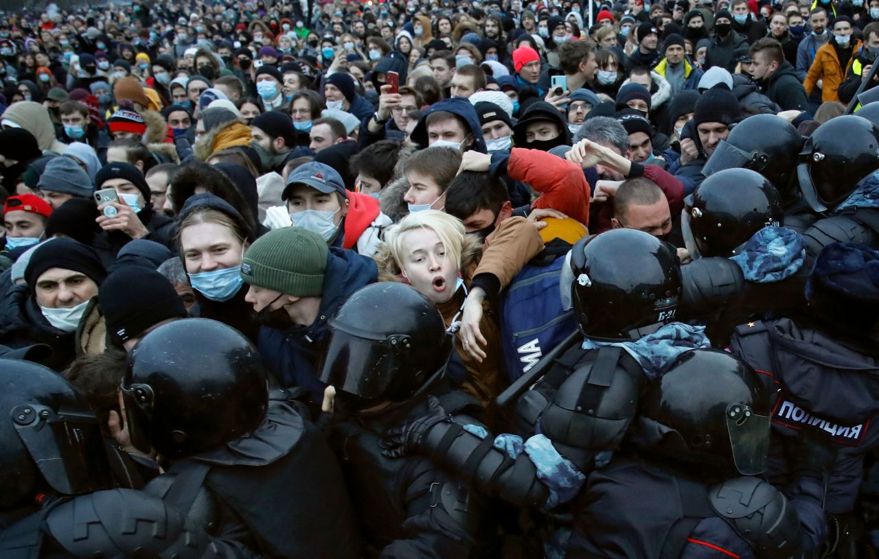 People clash with police in St. Petersburg, Russia, while protesting against <a href="https://www.cnn.com/2021/01/28/europe/navalny-russia-court-hearing-intl/index.html" target="_blank">the jailing of opposition leader Alexei Navalny</a> on Saturday, January 23. Navalny was detained by police on January 17, five months after he was poisoned with the nerve agent Novichok. He was placed on the country's federal wanted list last month for violating terms of probation related to a years-old fraud case, which he dismisses as politically motivated.