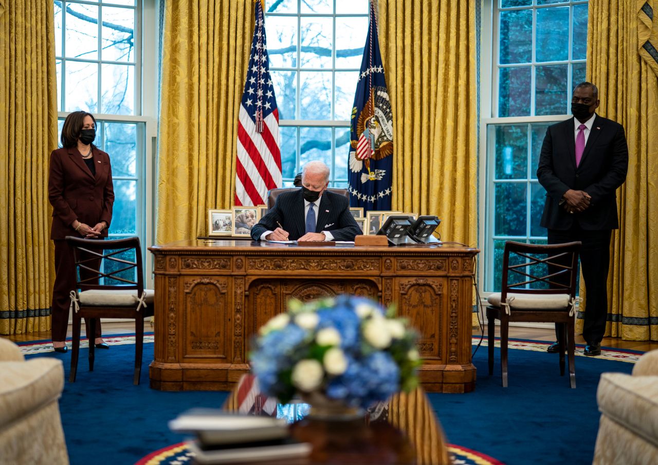 US President Joe Biden -- flanked by Vice President Kamala Harris and Defense Secretary Lloyd Austin -- signs an executive order in the White House Oval Office on Monday, January 25. The order <a href="https://www.cnn.com/2021/01/25/politics/lloyd-austin-transgender-military-harris-biden/index.html" target="_blank">repealed a Trump-era ban</a> on most transgender Americans joining the military.