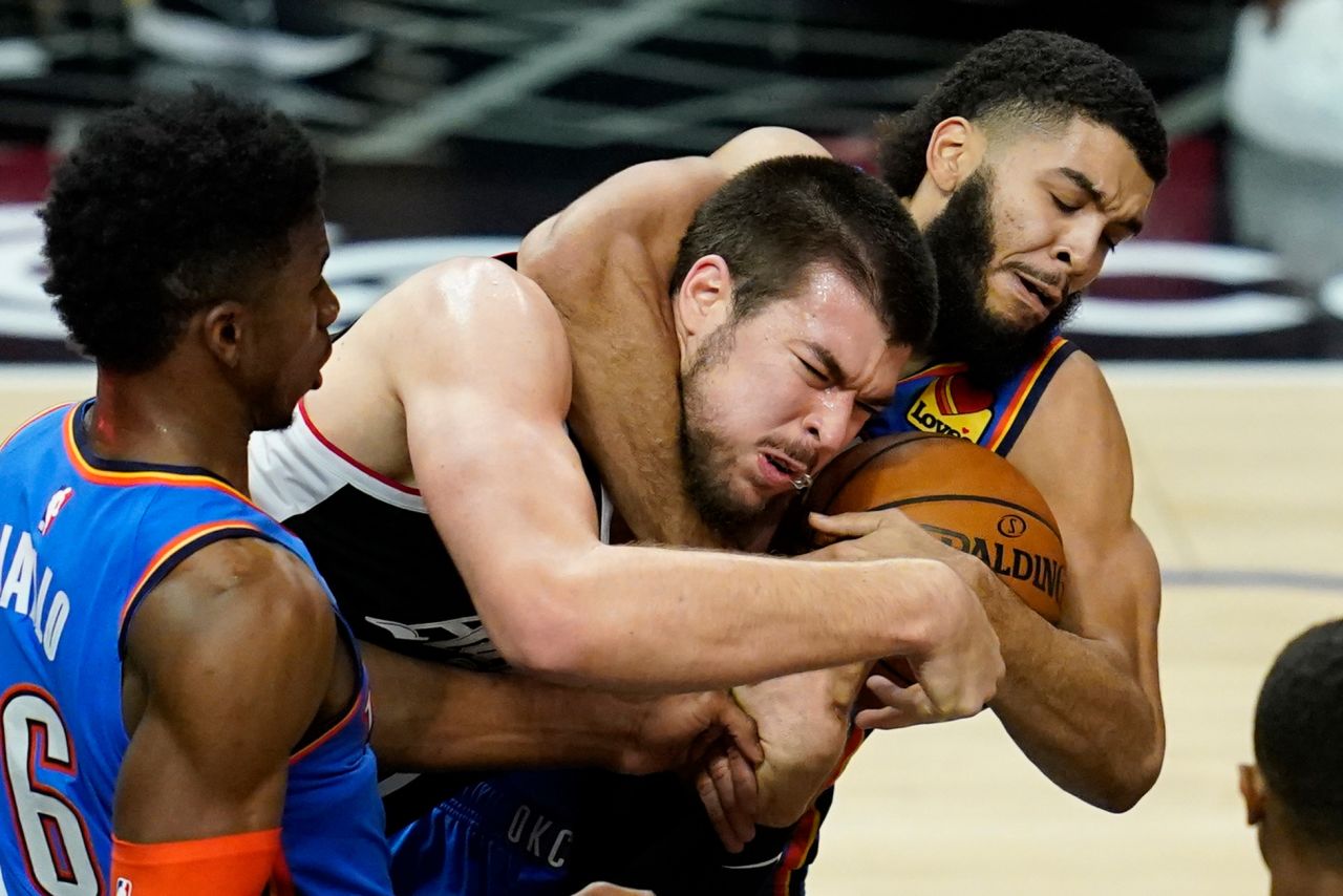 Los Angeles Clippers center Ivica Zubac gets roughed up while battling for a rebound with Oklahoma City's Kenrich Williams on Friday, January 22.