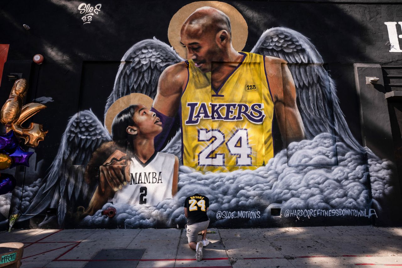 Adam Dergazarian pays his respects to basketball legend Kobe Bryant and his daughter, Gianna, in front of a mural in Los Angeles on Tuesday, January 26. The Bryants and seven other people <a href="https://www.cnn.com/2021/01/26/us/kobe-bryant-death-anniversary/index.html" target="_blank">were killed in a helicopter crash one year ago.</a>