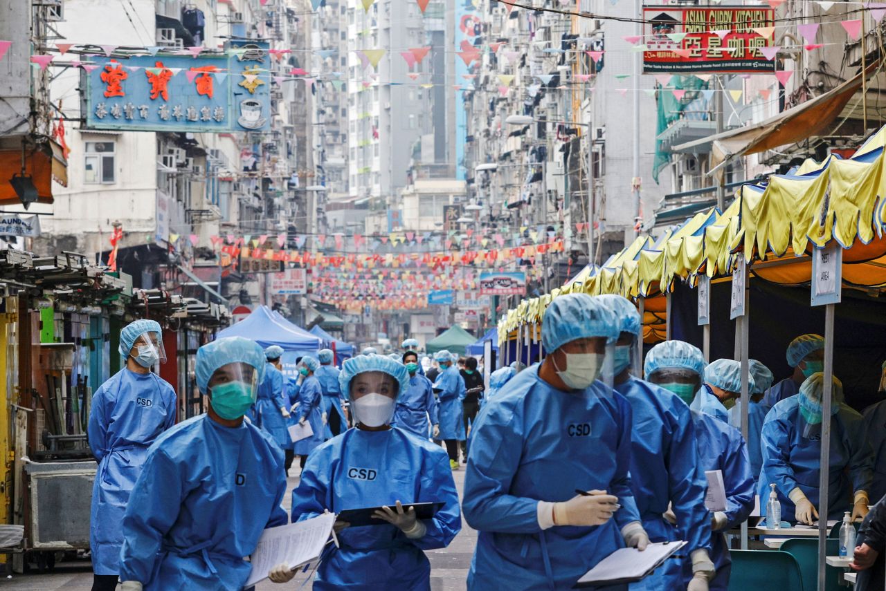 Health workers are seen inside a locked-down portion of Hong Kong to contain a Covid-19 outbreak on Saturday, January 23.