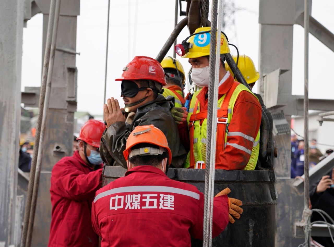 Rescue workers bring a miner up to the surface at the Hushan gold mine in Qixia, China, on Sunday, January 24. An explosion on January 10 <a href="https://www.cnn.com/2021/01/24/china/china-trapped-miners-intl-hnk/index.html" target="_blank">trapped 22 workers underground. </a>