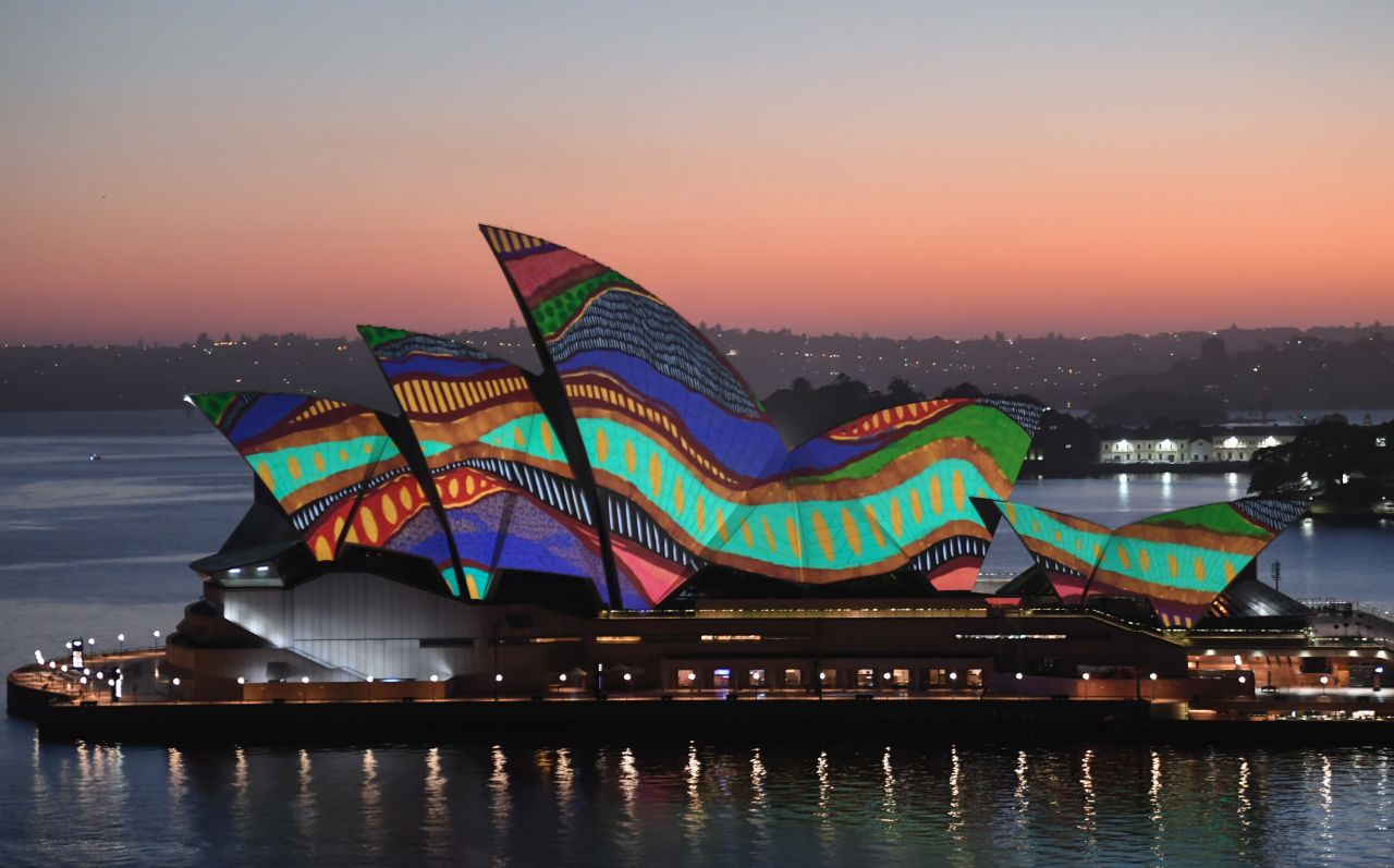 The sails of the Sydney Opera House are lit up at dawn on Tuesday, January 26. The artwork, "Angwirri" by Frances Belle-Parker, was part of Australia Day celebrations.