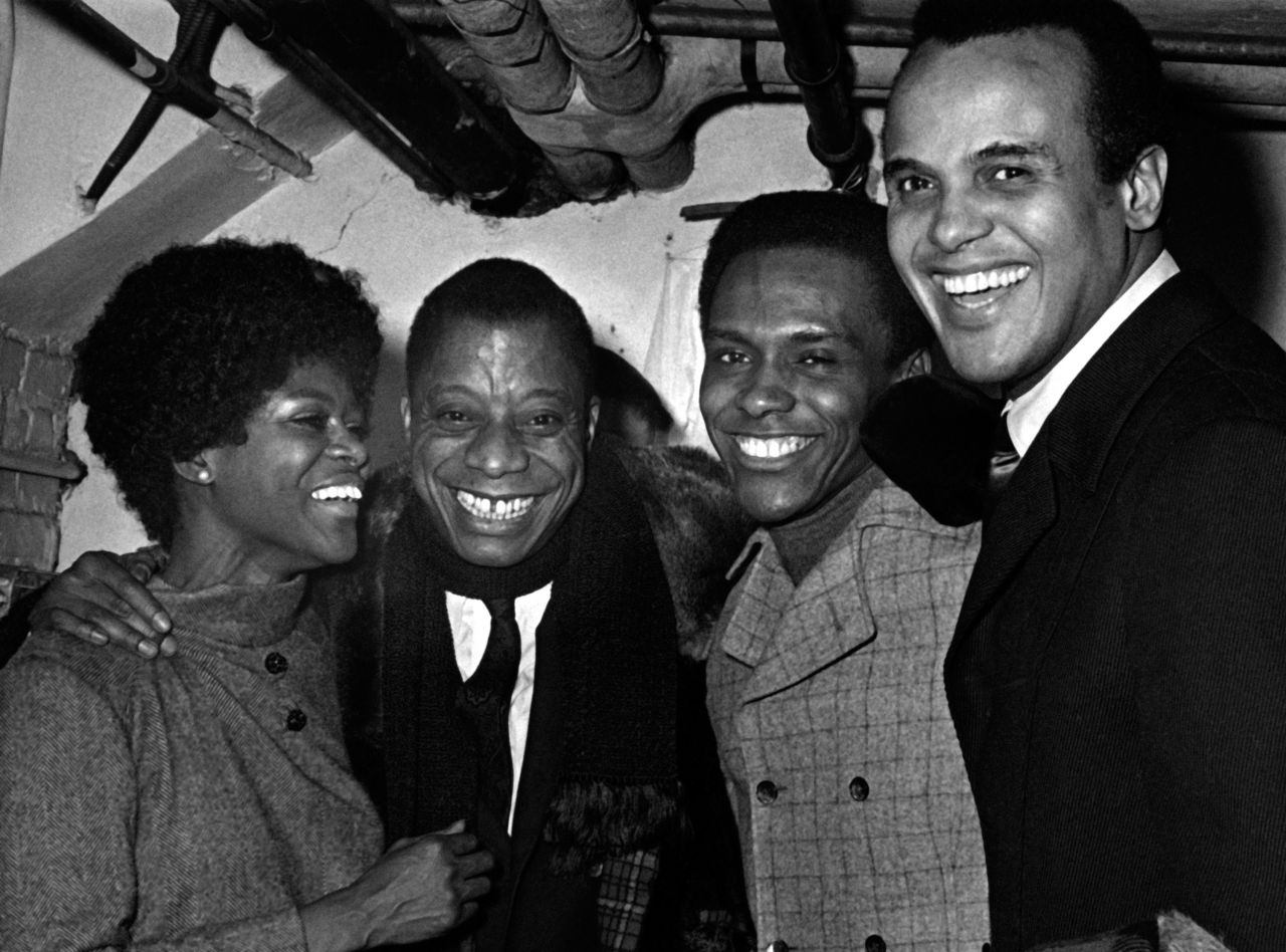 Tyson attends the To Be Young, Gifted and Black Gala in New York in 1969. Novelist James Baldwin is next to Tyson. Singer Harry Belafonte is on the right.