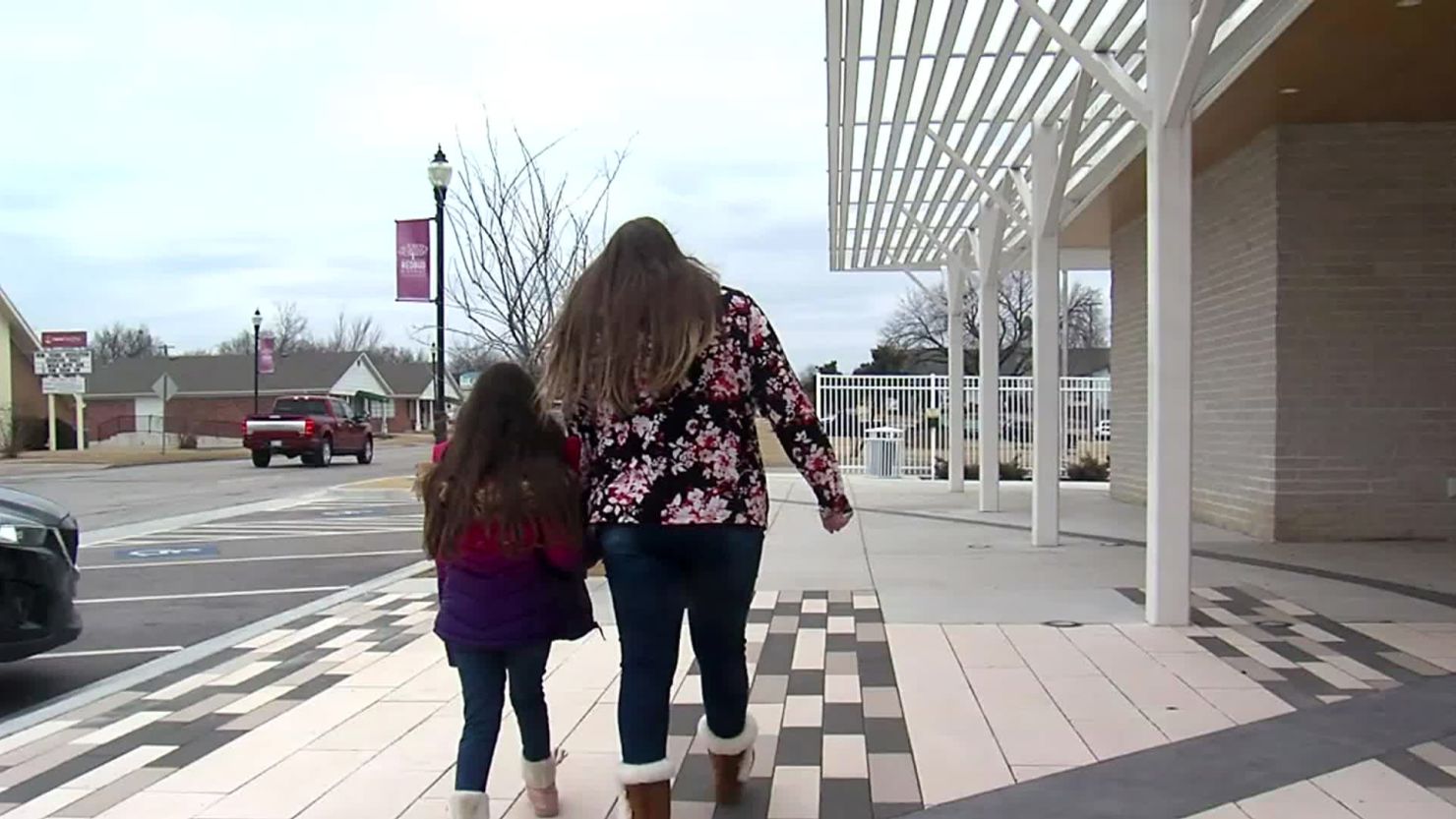Second grader Chloe Shelton and her mom Delanie Shelton hold hands while they walk together. Chloe was kicked out of school after saying she had a crush on another girl.