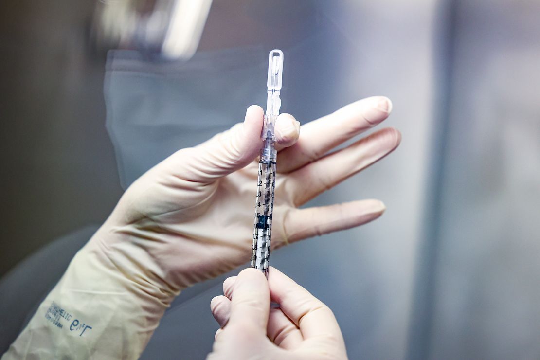 A VA medical tech prepares a vaccine dose.