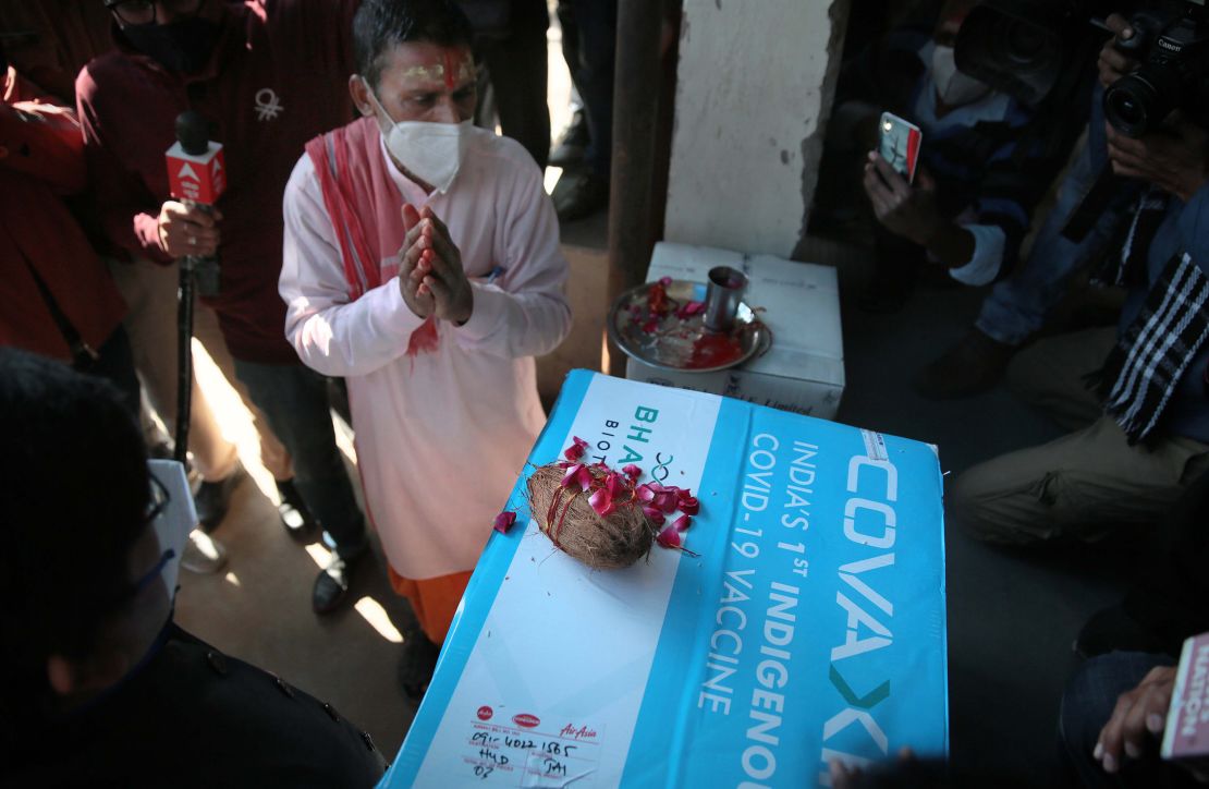 A priest performs prayer rituals on a carton containing the first consignment of Bharat Biotech's Covaxin vaccine.