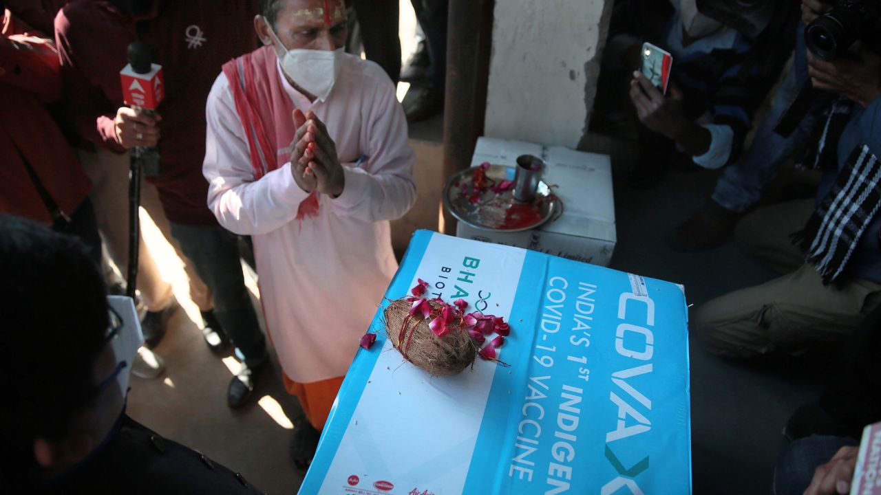 A priest performs prayer rituals on a carton containing the first consignment of Bharat Biotech's Covaxin vaccine.