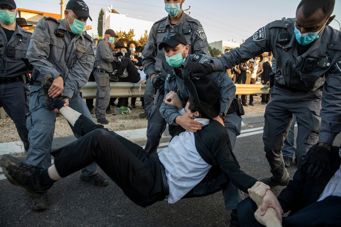 Israeli police clear ultra-Orthodox Jews blocking a highway in a protest in Bnei Brak on December 27, 2020, against the detention of a member of their community who refused to do military service.