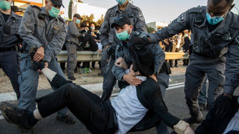 Israeli police clear ultra-Orthodox Jews blocking a highway in a protest in Bnei Brak on December 27, 2020, against the detention of a member of their community who refused to do military service.