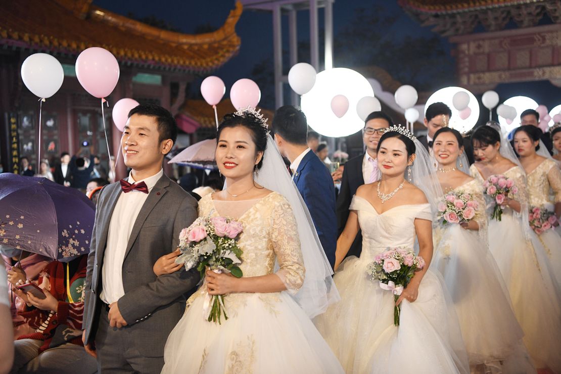 Newlywed couples from a Wuhan hospital attend a group wedding at the Yellow Crane Tower on October 20, 2020 in Wuhan, China.