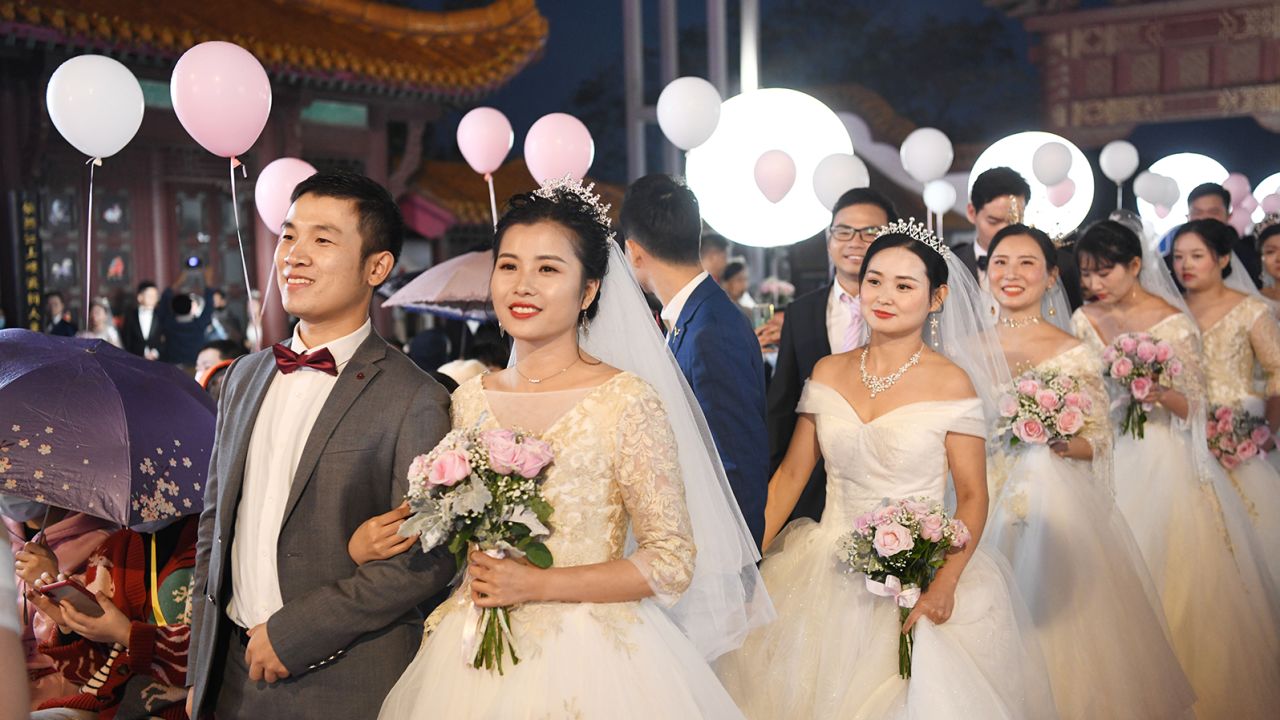 Newlywed couples from a Wuhan hospital attend a group wedding at the Yellow Crane Tower on October 20, 2020 in Wuhan, China.