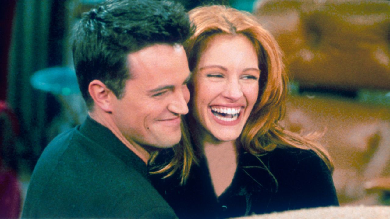 Matthew Perry and Julia Roberts hug on the set of "Friends."