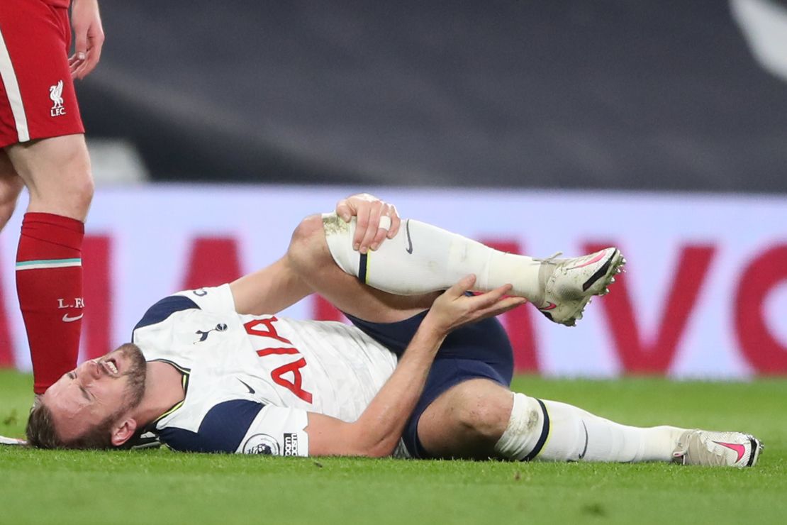 Kane lies on the pitch with an apparent injury during the game against Liverpool.