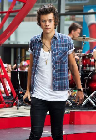 Styles leans into his new-found boy band charm with an open shirt, rolled sleeves and tank top. Here he is performing in New York City in the summer of 2013 after splitting with Swift in January. 