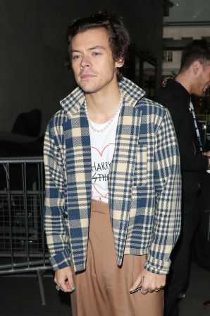 Styles leaving BBC Radio One after performing in the Live Lounge in 2019. He is wearing a t-shirt he designed with Gucci Creative Director Alessandro Michele.