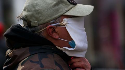 A man wears a double mask as he visits Times Square in New York on December 10, 2020.