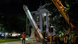 Crew members in Decatur, Georgia work to remove the Confederate monument brought down on June 19, 2020.