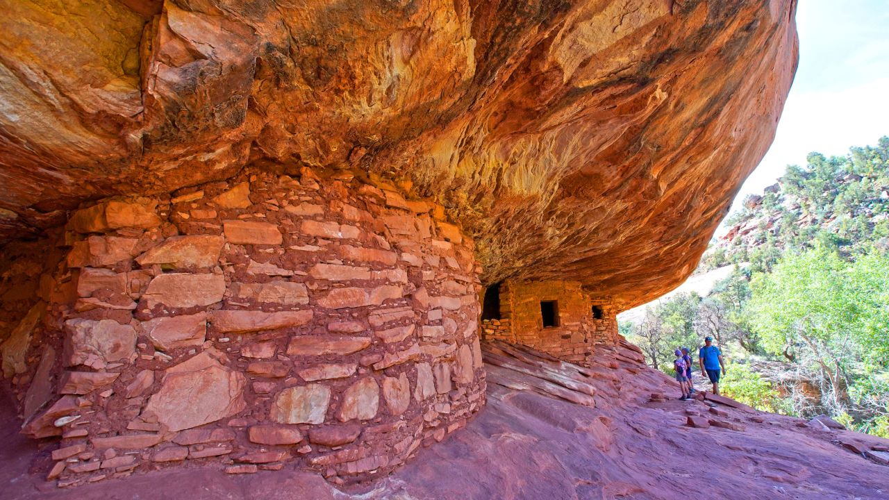In this June 14, 2019, file photo, hikers look around the House on Fire Indian ruins in Mule Canyon, part of the Bears Ears National Monument  outside Blanding, Utah.