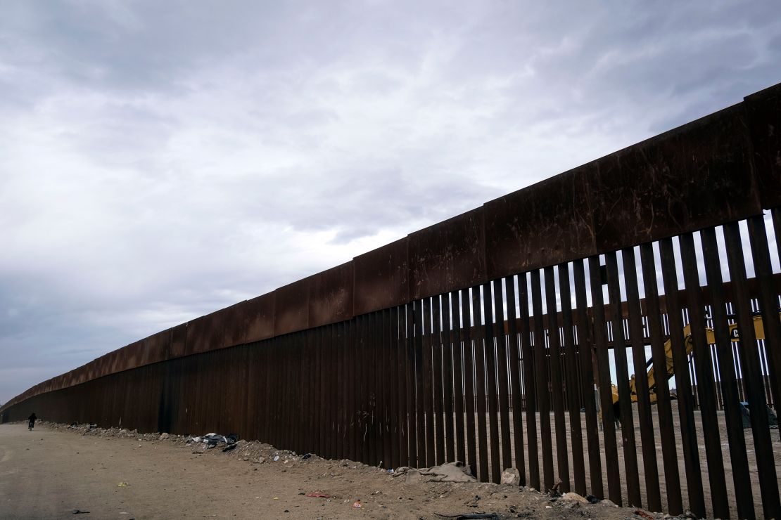 A construction vehicle parks between fences at a reinforced section of the US-Mexico border fencing eastern Tijuana, Baja California state, Mexico on January 20, 2021.