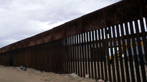 A construction vehicle parks between fences at a reinforced section of the US-Mexico border fencing eastern Tijuana, Baja California state, Mexico on January 20, 2021.