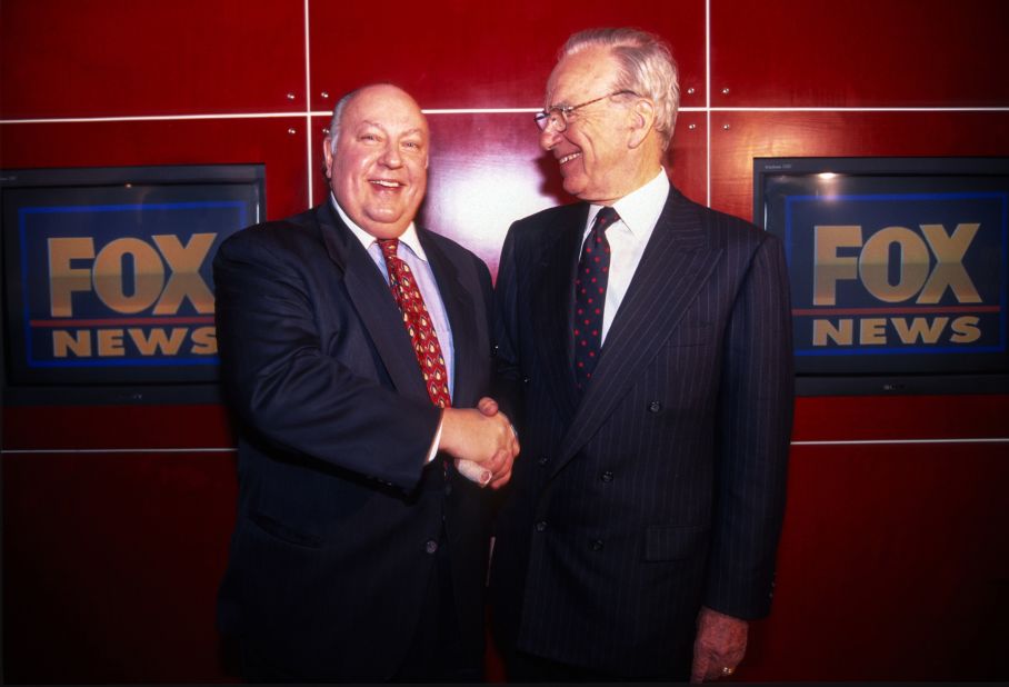 Murdoch shakes hands with Roger Ailes after naming Ailes the head of the new Fox News Channel in 1996.