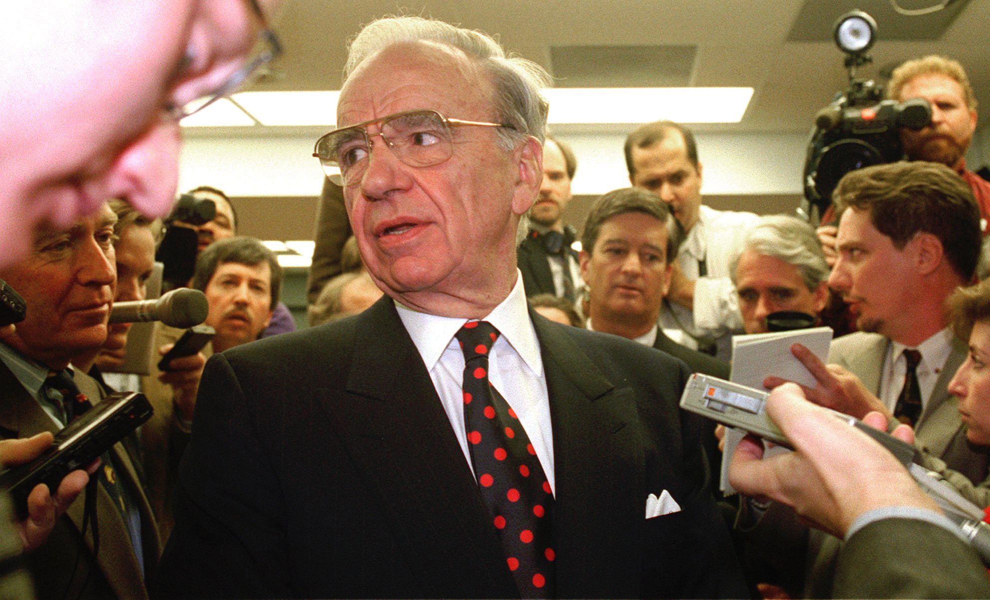 Murdoch is followed by reporters as he arrives for a hearing of the Federal Communications Commission in 1995.