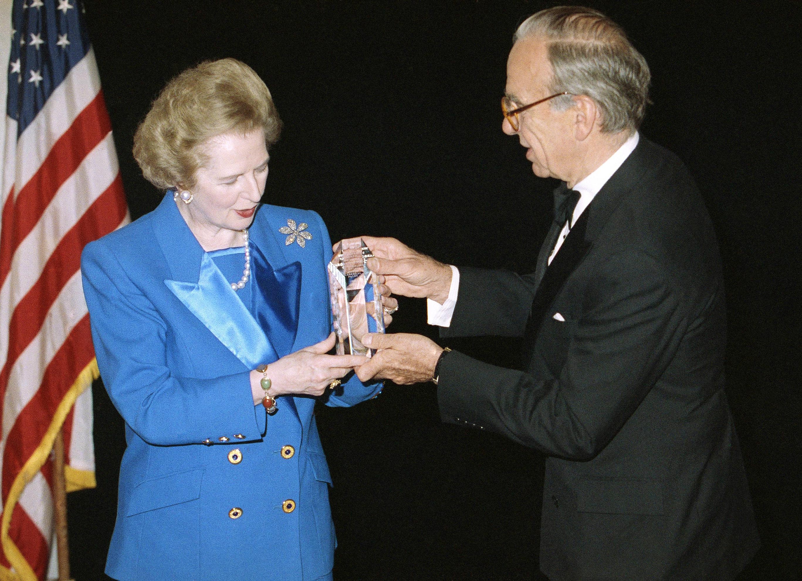 Murdoch presents former British Prime Minister Margaret Thatcher with a humanitarian award in 1991.