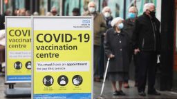 Visitors queue before receiving the AstraZeneca Plc and the University of Oxford Covid-19 vaccine outside a closed down Debenhams Plc department store, in Folkestone, U.K., on Wednesday, Jan. 27, 2021. A day after the British death toll passed 100,000, U.K. Prime Minister Boris Johnson said the government will review the impact of pandemic measures and the effectiveness of the vaccine program in mid-February. Photographer: Chris Ratcliffe/Bloomberg via Getty Images
