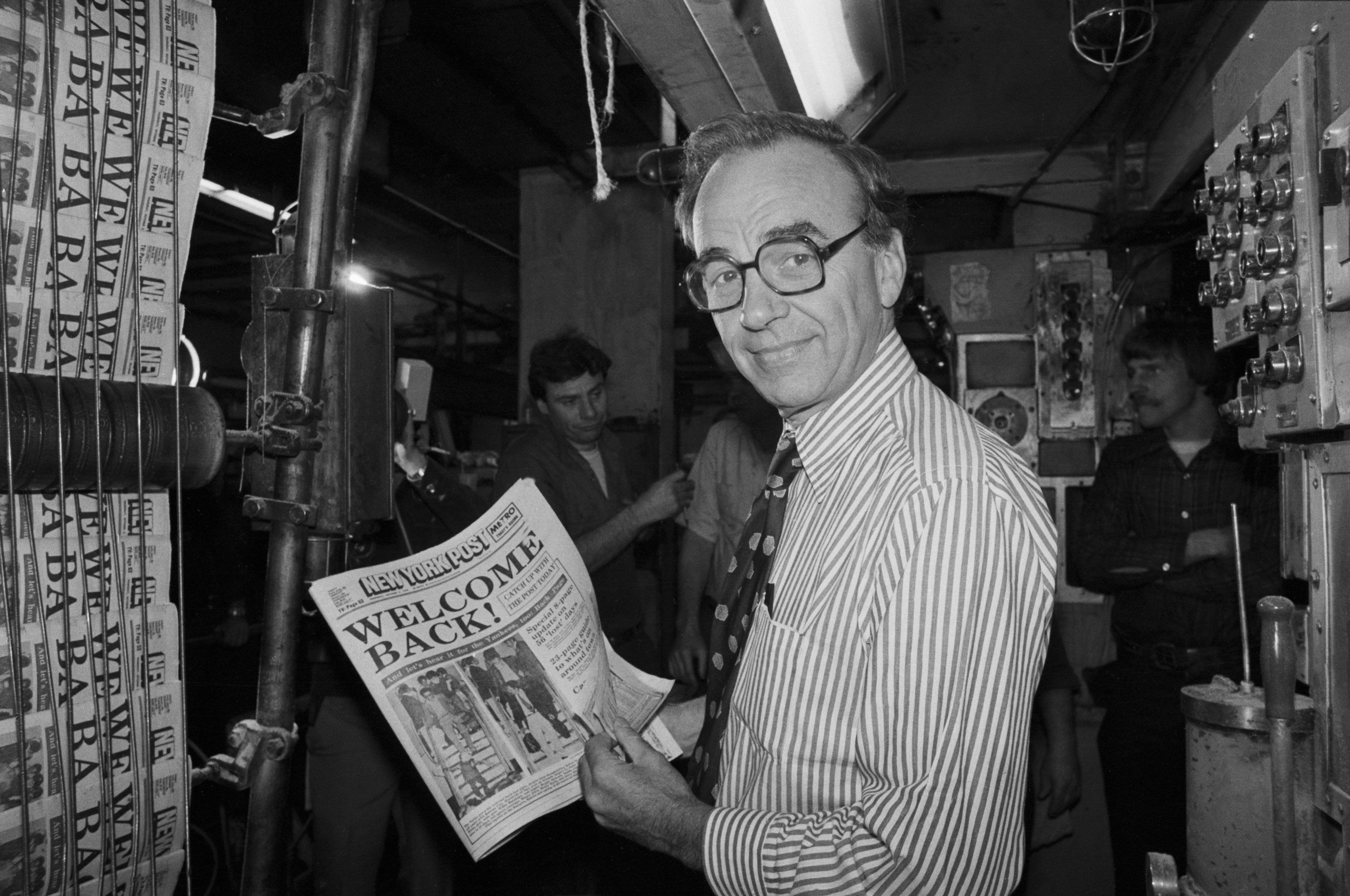 Murdoch holds up a copy of the New York Post in 1978.