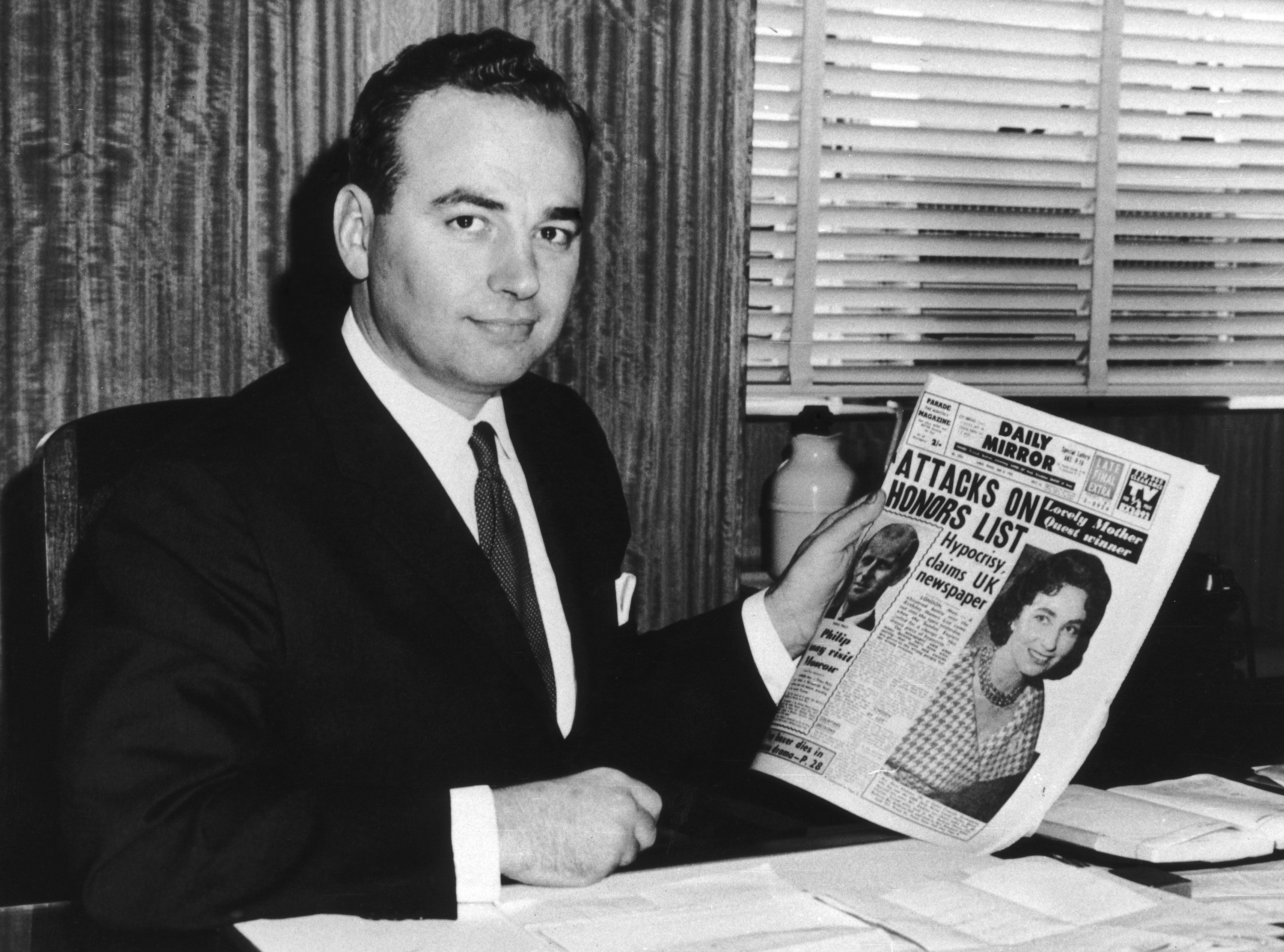 Murdoch holds a copy of the Sydney tabloid the Daily Mirror in 1960. He bought the newspaper that year.