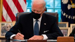US President Joe Biden signs an Executive Order reversing  Trump era ban on Transgender serving in the military while in the Oval Office of the White House in Washington, DC, on January 25, 2021. 
