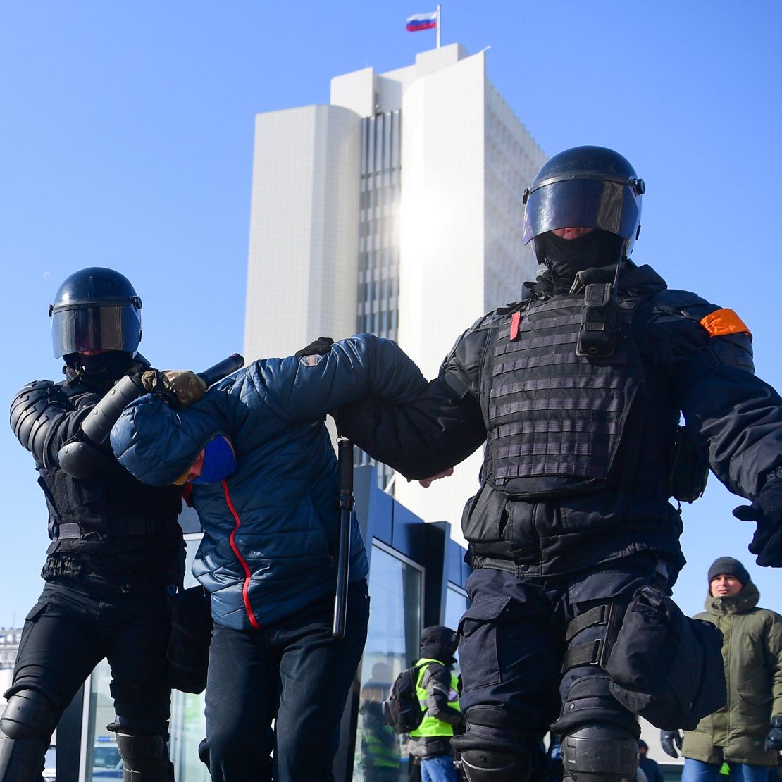 Riot police detain a man during a rally in support of jailed opposition leader Alexey Navalny in the far eastern city of Vladivostok on Sunday.