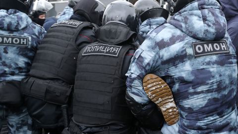 Riot police detain a participant in an unauthorized protest in support of Navalny in central Moscow on Sunday.