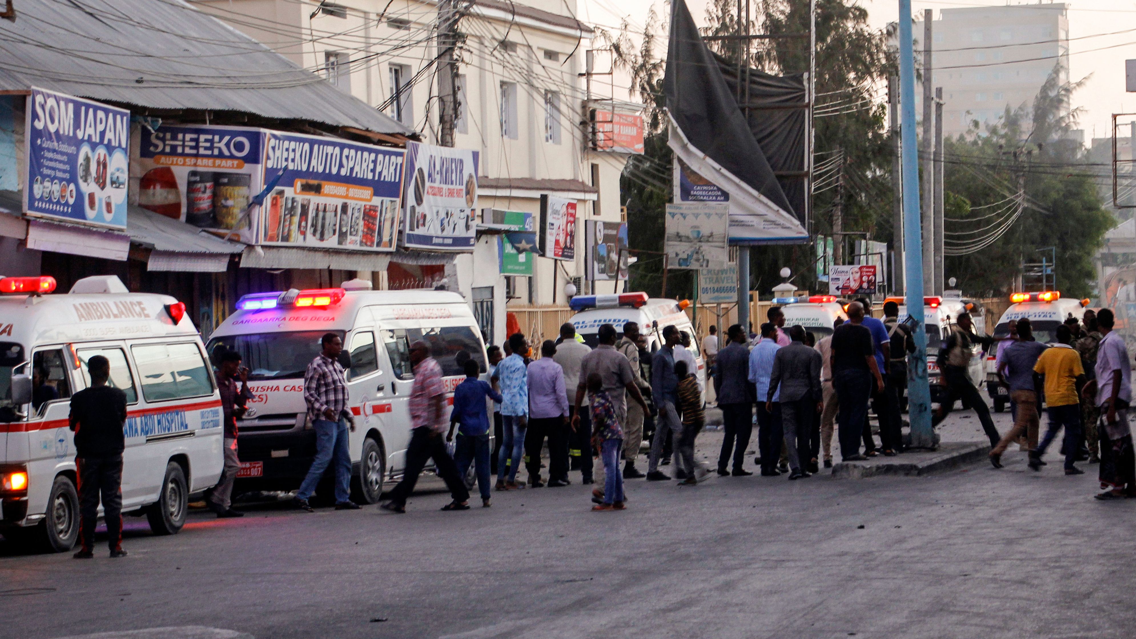 Ambulances and security forces gather on the street outside the Afrik hotel in Mogadishu on Sunday