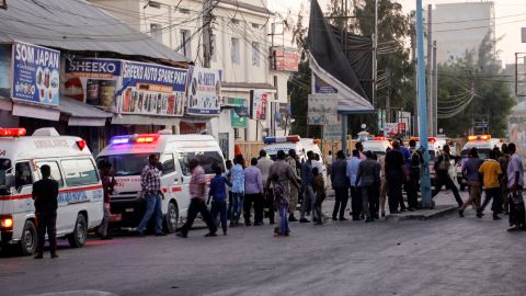 Ambulances and security forces gather on the street outside the Afrik hotel in Mogadishu after an explosion and an attack by gunmen