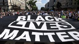 Demonstrators deploy a " Black Lives Matter" banner near the White House  during a demonstration against racism and police brutality, in Washington, DC on June 6, 2020. 