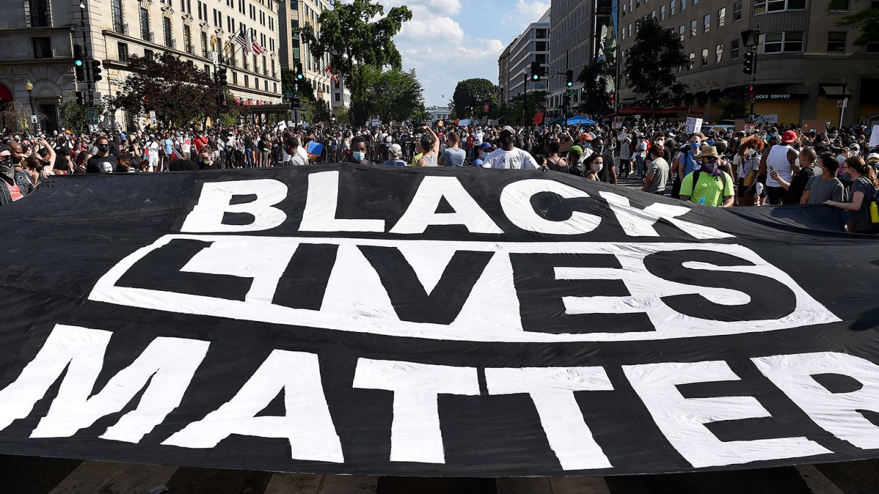 Protesters deploy a "Black Lives Matter" banner near the White House during a demonstration against racism and police brutality, in Washington, DC, on June 6, 2020. 