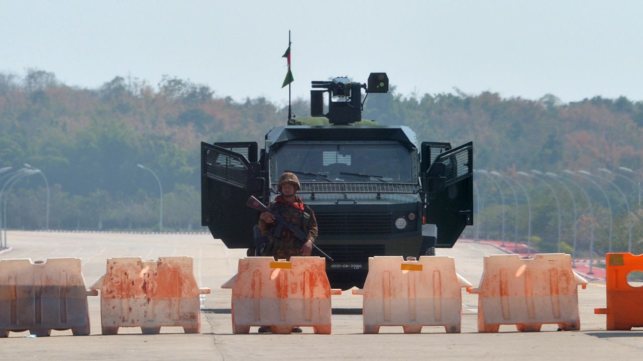 A soldier stands guard on a blockaded road to Myanmar's parliament in Naypyidaw on February 1, 2021, after the military detained the country's de facto leader Aung San Suu Kyi and the country's president in a coup. 