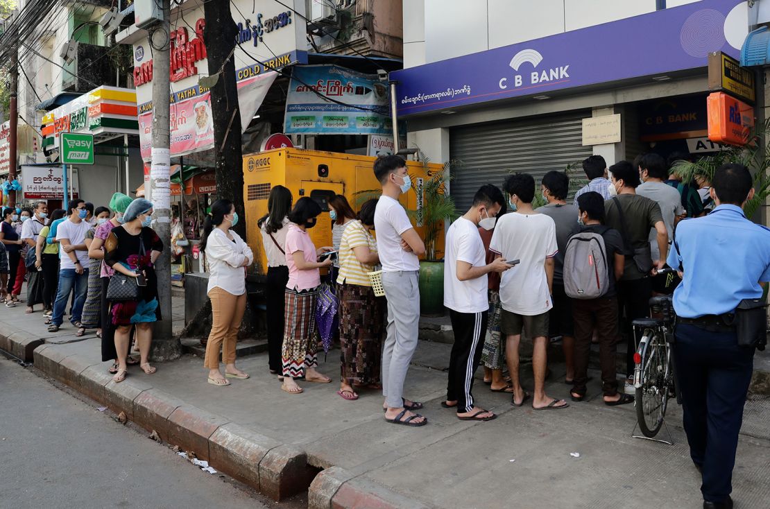 Residents in Yangon line up in front of an ATM machine of a closed bank on February 1, 2021.