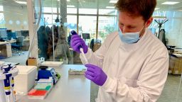 A scientist at the Sanger Institute prepares the Covid samples for sequencing. More than 700 positive samples are sequenced in a single run of one machine, which takes around five days.