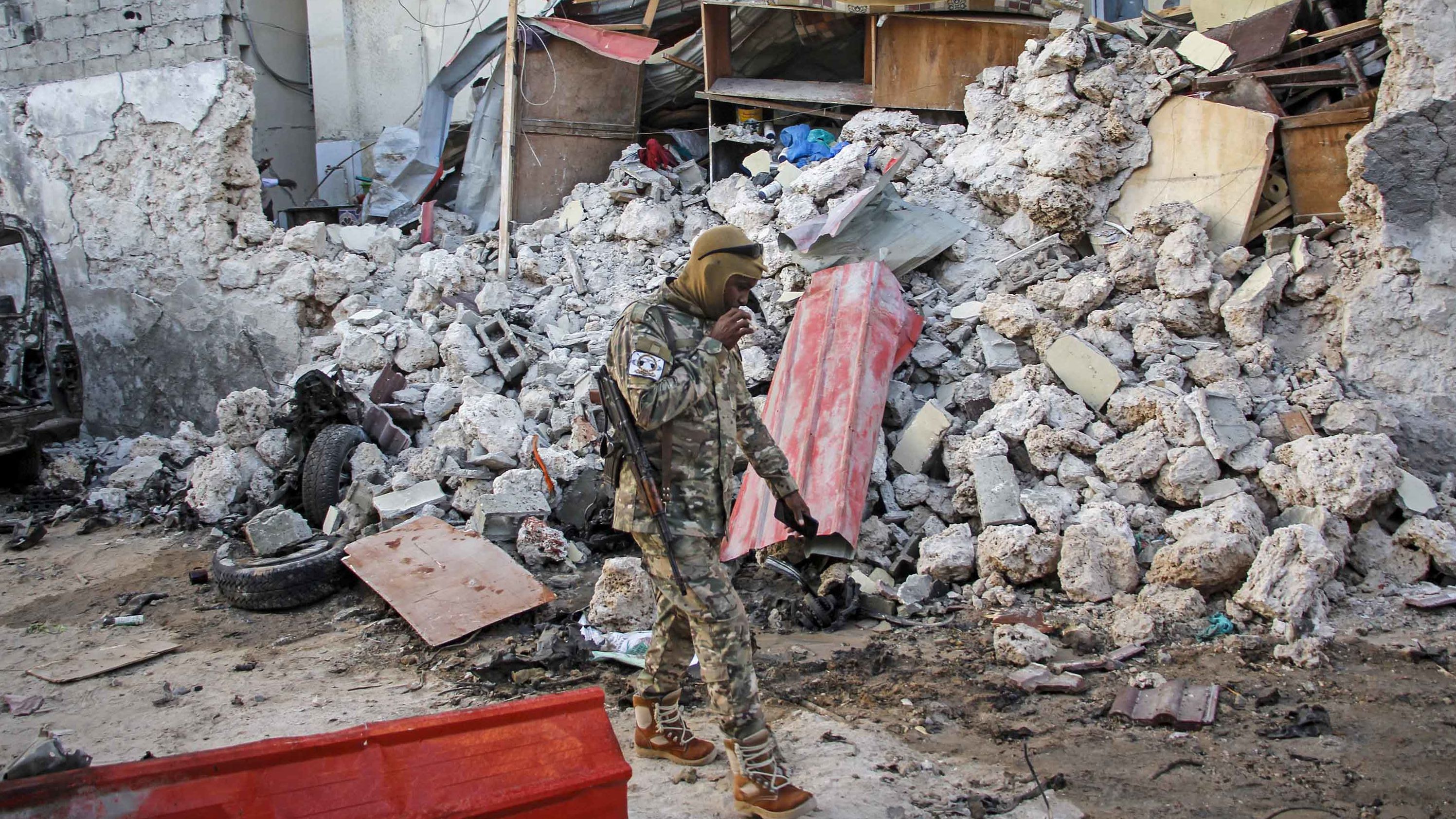 A soldier walks past wreckage in the aftermath of an attack on the Afrik hotel in Mogadishu