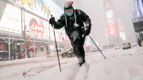Steve Kent skis through Times Square in New York on Monday.