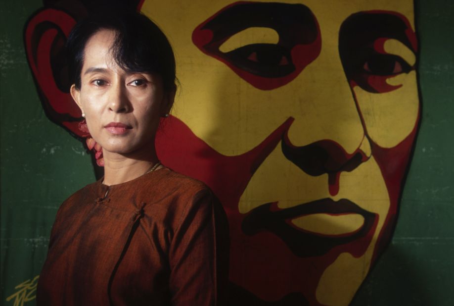 Suu Kyi poses in front of a portrait of her father in 1999. In 2000, she was once again placed under house arrest. 
