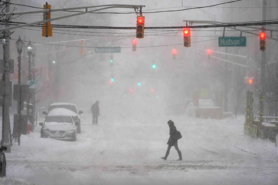 Pedestrians make their way through heavy snow in Hoboken on Monday.