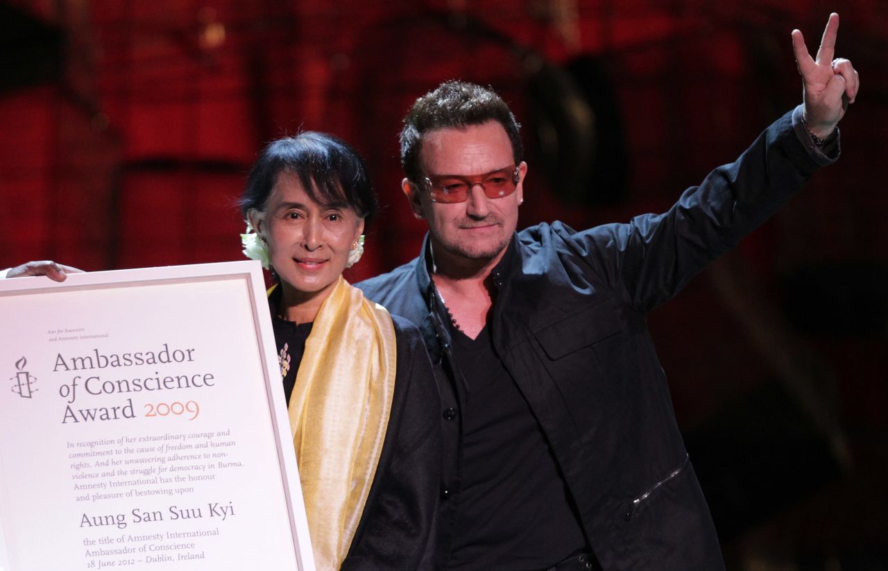 Suu Kyi accepts the Ambassador of Conscience Award next to U2 singer Bono during a European tour in 2012.