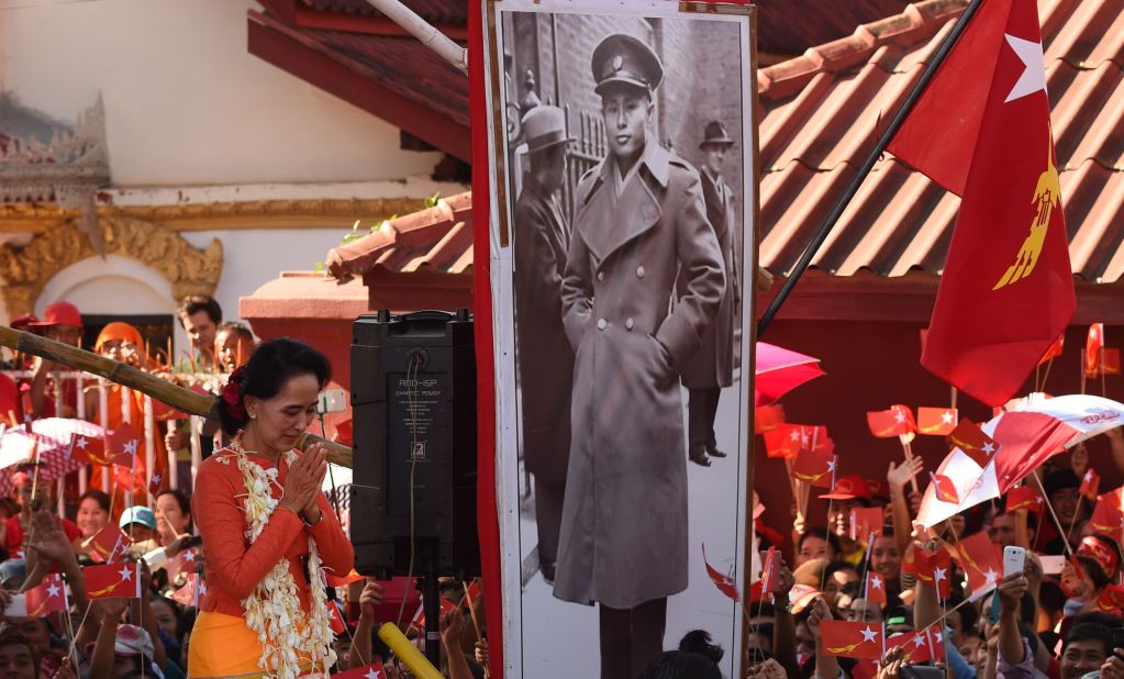 Suu Kyi descends from a stage decorated with a portrait of her late father during a campaign rally in 2015.