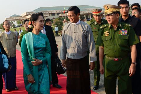 Suu Kyi walks with Gen. Min Aung Hlaing, the country's military leader, at the Naypyidaw city airport in 2016.