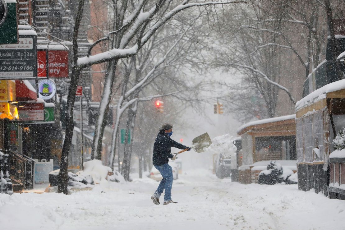 A person shovels snow in New York's Greenwich Village neighborhood on Monday.